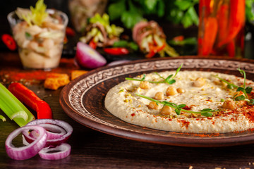 The concept of Arabic cuisine. Oriental hummus with grilled sesame and pistachios. Laid arabic table for the holiday. Background image. Top view, copy space