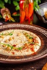 The concept of Arabic cuisine. Oriental hummus with grilled sesame and pistachios. Laid arabic table for the holiday. Background image. Top view, copy space