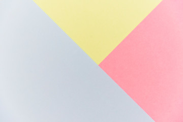 Blue, pink and yellow pastel color paper geometric flat lay background