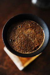 Alternative manual coffee brewing in porous ceramic paperless dripper filter.