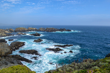Fototapeta na wymiar Sea cliffs in blue waters of the Pacific ocean
