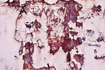Cracked soft pink paint surface with rusty dark brown details close up, grunge horizontal shabby background