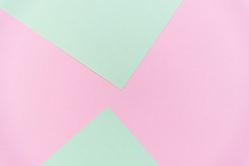 Abstract pastel green and pink pastel color paper geometric flat lay background