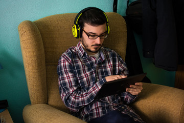 Man uses tablet on sofa in his home