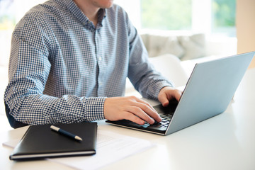 Closeup photo of man working with laptop