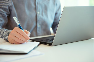 Closeup photo of man working with laptop