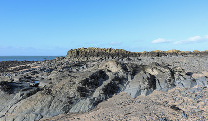 Landscape with rocks and blue sky. The Irish coast. 