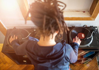 Woman Dj working with vinyl records, overhead view