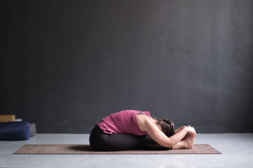 Fototapeta na wymiar woman practicing yoga, Seated forward bend pose