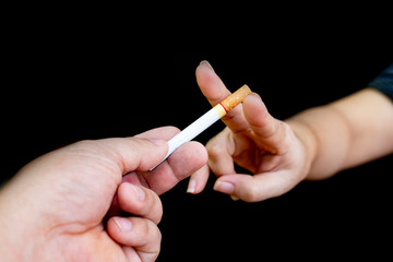 Image of cigarette in hand with smoke