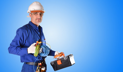 Uniformed electrician with safety protections and work tools background