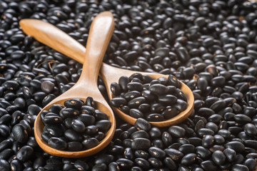 close-up of black beans in wooden spoon