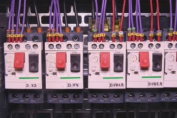Image shows control cubicle. Electric device and circuit breakers inside power case.