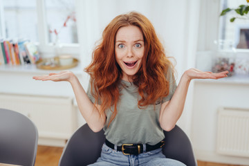 Young woman shrugging her shoulders