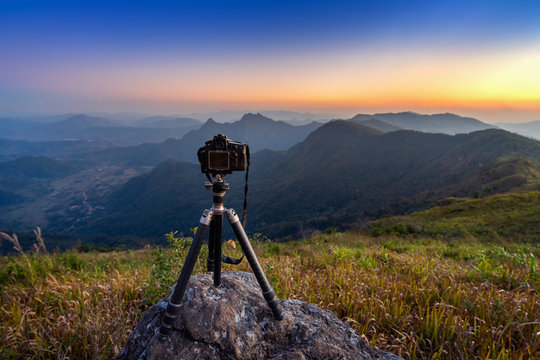 Digital camera on tripod in the mountains.