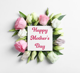 Beautiful Eustoma flowers and card on light background