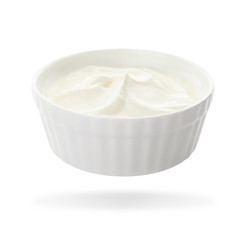 Ceramic bowl with delicious sour cream on white background