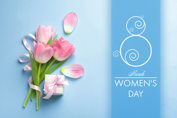 Flat lay composition of tulips on blue background. International Women's Day
