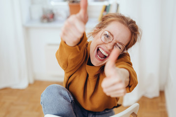 Happy girl showing thumbs up gestures