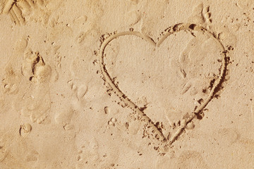 Drawing of heart on sandy surface, top view with space for text