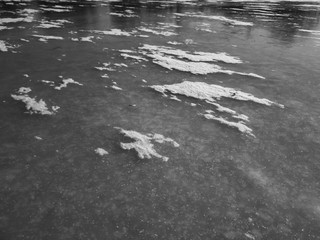 Snow on the ice of the river. Frozen river. Ice on the river.