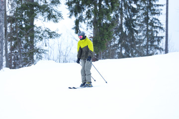 Skier on slope at resort. Winter vacation