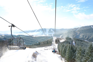 Beautiful mountain landscape with chairlift. Winter vacation