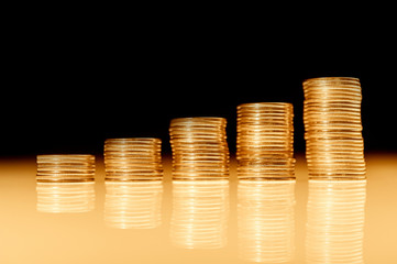 Stack of gold coins macro. Rows of coins for finance and banking concept. Economy trends background.