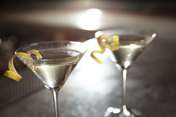 Glasses of lemon drop martini cocktail in bar, closeup. Space for text