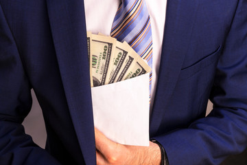 A man in an expensive jacket that is packed with money on white background.Concept on corruption in...