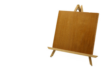 Empty easel with a wooden board isolated on white background.