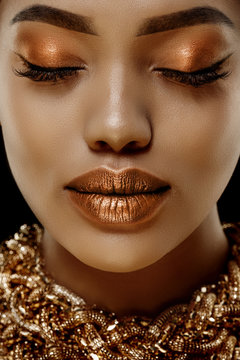Gold Luxury black skin woman African Ethnic female face. Young african american model with jewelry