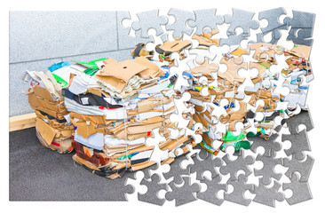 Learning to recycle - concept image in jigsaw puzzle shape - Stacks of paper and cardboard ready to...