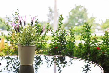 small flower vase decor on black glass table