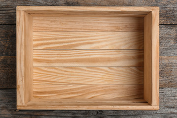 Empty crate on wooden background, top view