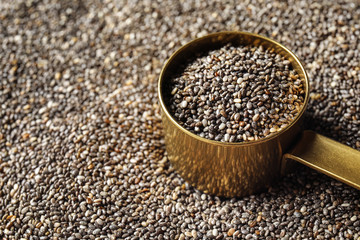 Saucepan of chia seeds on grains, closeup with space for text