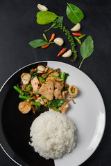 Stir fried with spicy pork, squid and fresh herbs in Thai call Pad-Cha