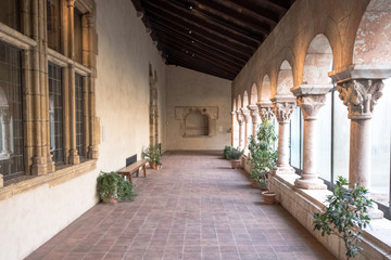 interior classic architecture garden hallway walkway. Stone pillar colomuns outsde pathway.