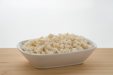 The cottage cheese in a bowl isolated on white background