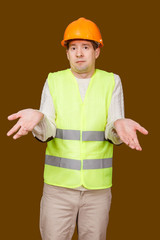 the man in a construction helmet, a vest, makes a helpless gesture in perplexity