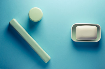 soap and tooth brush on a colored background