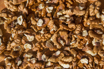 Closeup of Peeled Walnuts pile. Walnuts Background on wooden cutting board. Selective Focus, nuts with many different textures