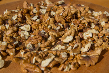 Closeup of Peeled Walnuts pile. Walnuts Background on wooden cutting board. Selective Focus, nuts with many different textures