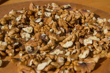 Closeup of Peeled Walnuts pile. Walnuts Background on wooden cutting board. Selective Focus, nuts with many different textures