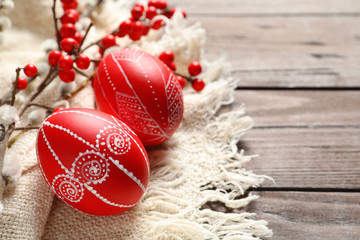 Red painted Easter eggs on wooden table, closeup. Space for text