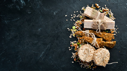 Healthy snacks. Oatmeal, muesli, flax. On a black background. Top view. Free space for your text.