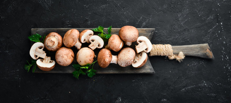 Champignons Mushrooms on a black background. Top view. Free copy space.