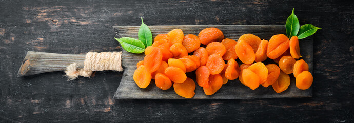 Dried apricots on a black background. Dried fruit Top view. Free space for your text.