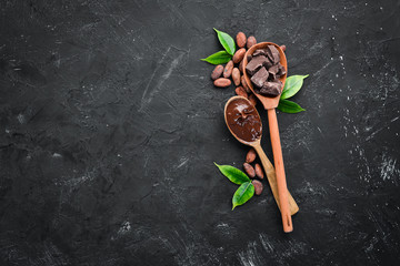 Chocolate in a wooden spoon. cocoa. Top view.