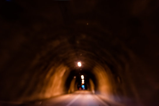 Almannaskardsgong or Almannaskard tunnel inside abstract view near Hofn, Iceland with lights lamp path illuminated blurry blurred in dark passage road highway